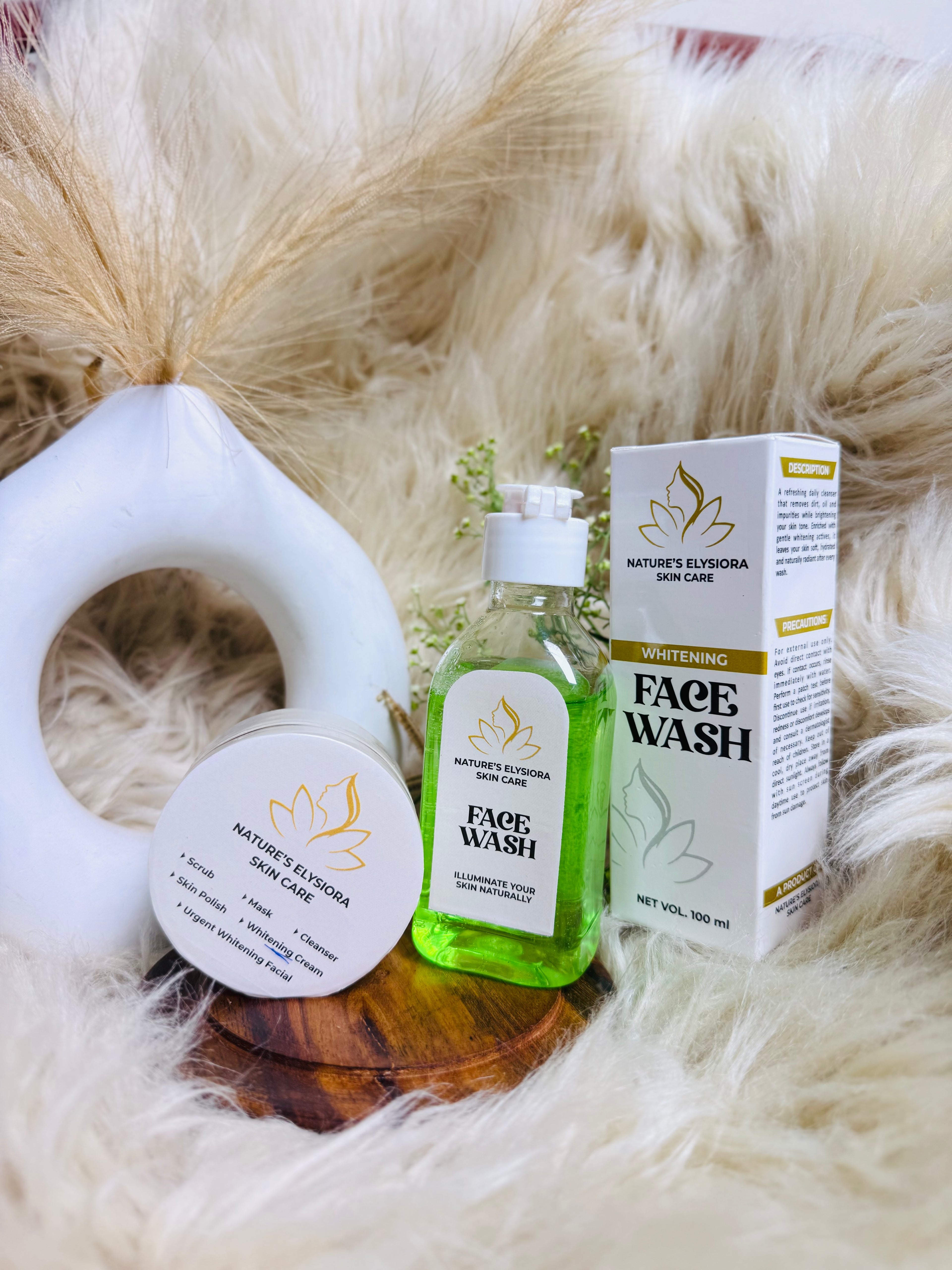 Nature's Ellyora skincare products including face wash, cream, and box on a fluffy white background