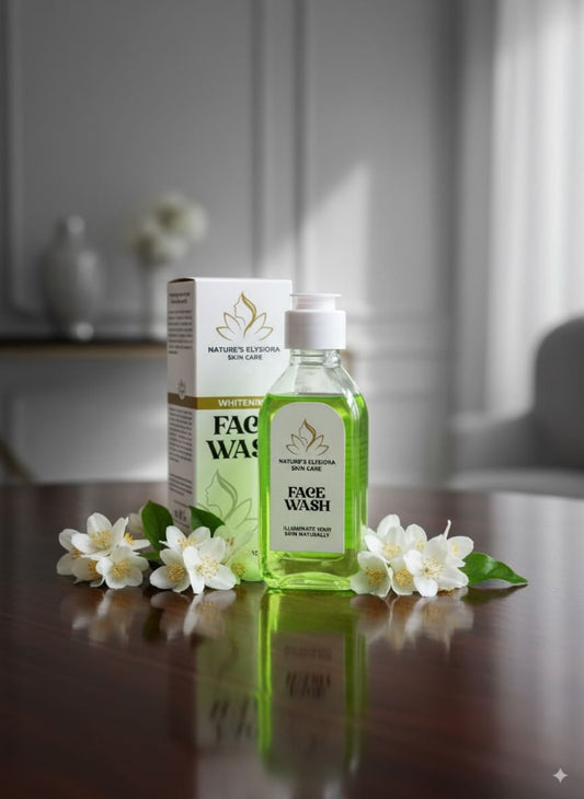 Green face wash bottle with packaging and white flowers on a reflective surface