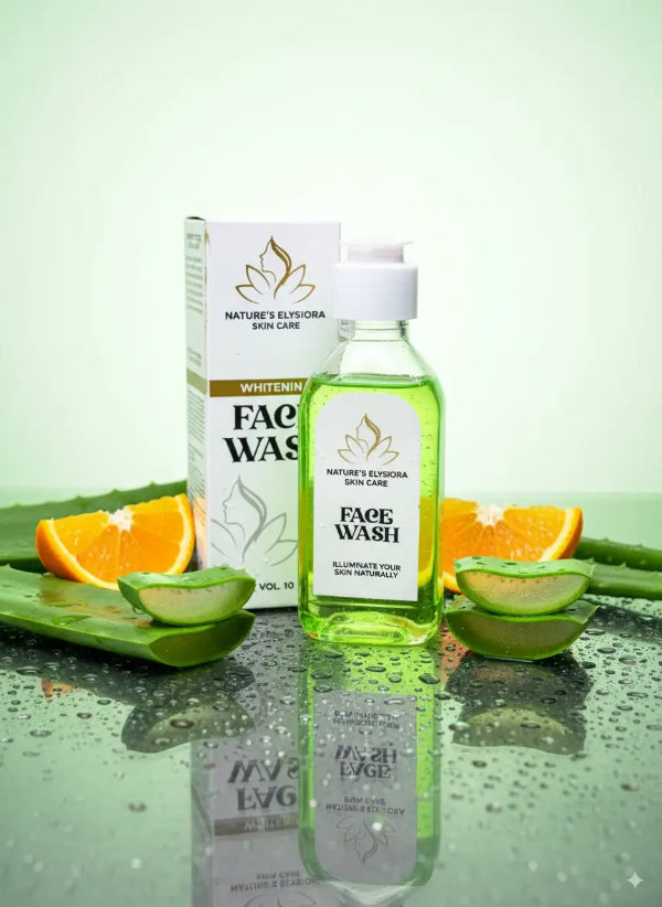 Face wash bottle with packaging on a reflective surface with fruits and aloe vera leaves.